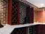 Granite counter, wine racks, and brick tile back splash